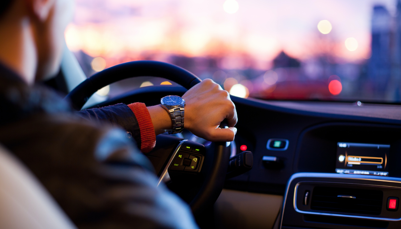 man driving in electric vehicle depicting property management technology