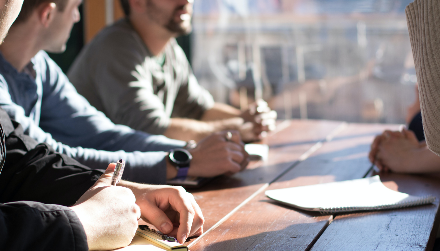 customers seated at table learning about operations platform implementation