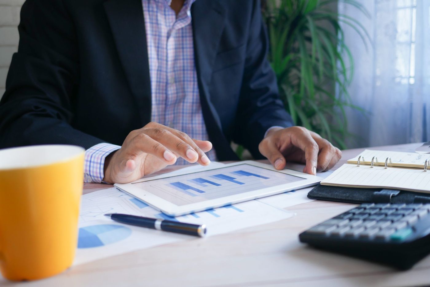 man crunching numbers on computer depicting budget streamlining